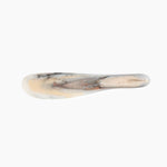 Dinosaur Designs Temple Cake Knife cake knife and server in sandy pearl colored resin.